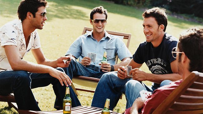 men plaing in card game and drinking beer