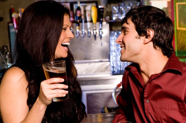 man and woman with glass of beer